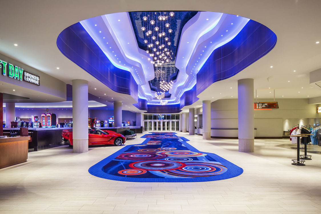 The lobby of a hotel with a blue carpet.