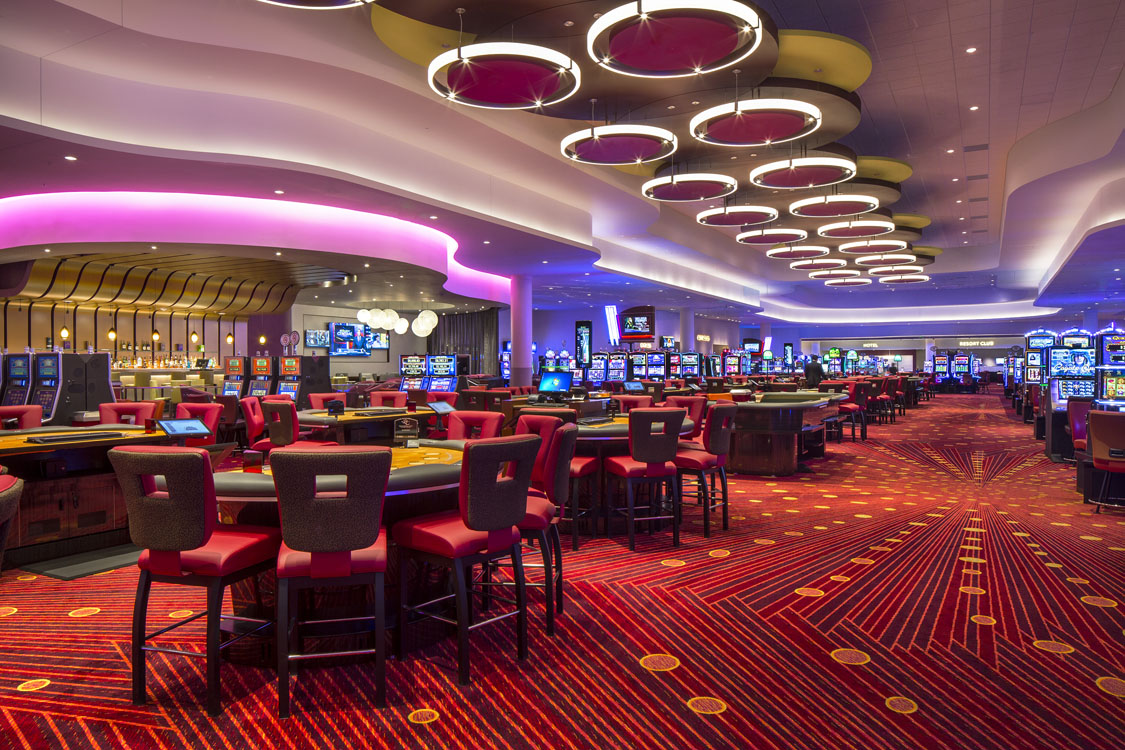A casino with a large number of tables and chairs.