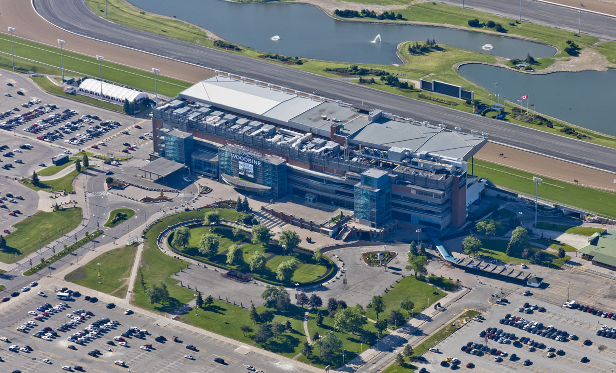 An aerial view of a parking lot and a racetrack.