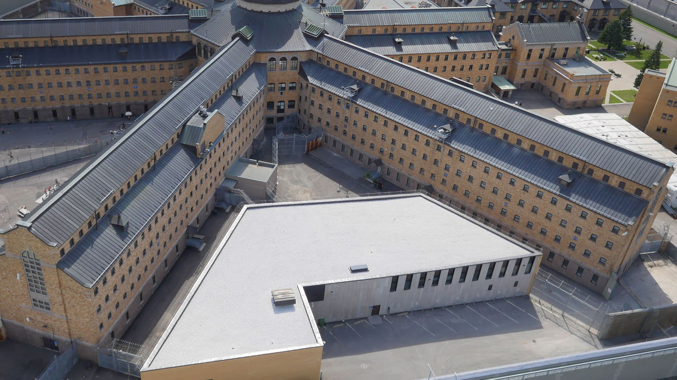 An aerial view of a large building with a roof.