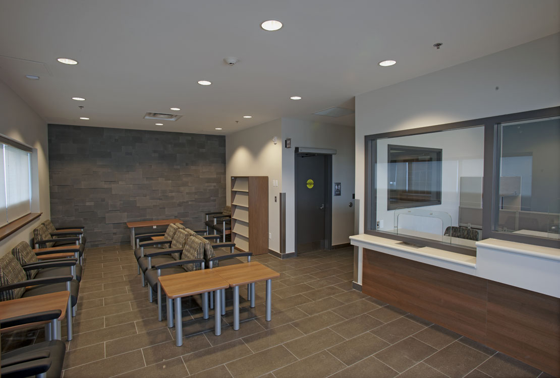 A waiting room with a desk and chairs.