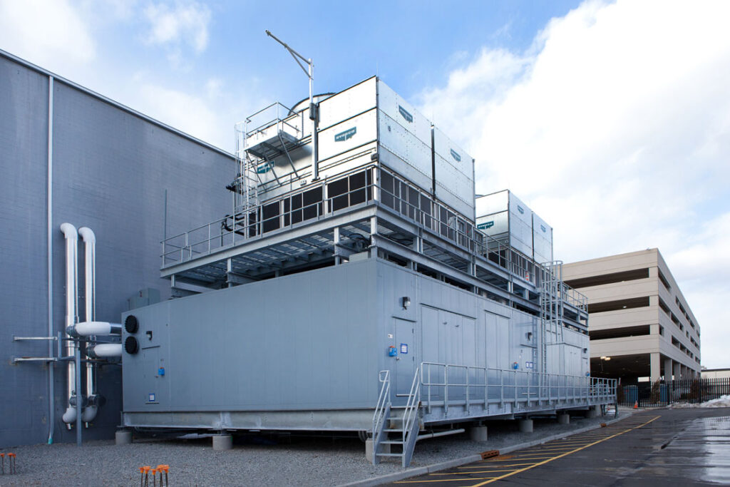 A large building with a large cooling tower on top of it.