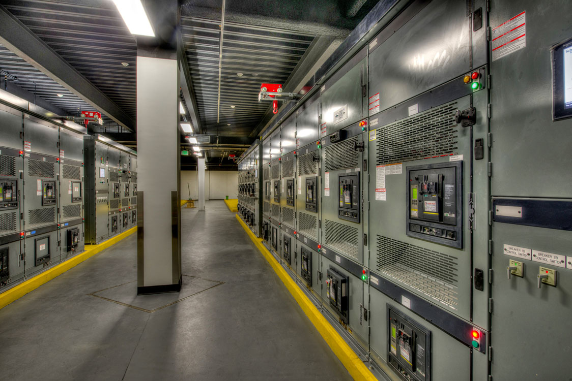 A row of electrical panels in a room.