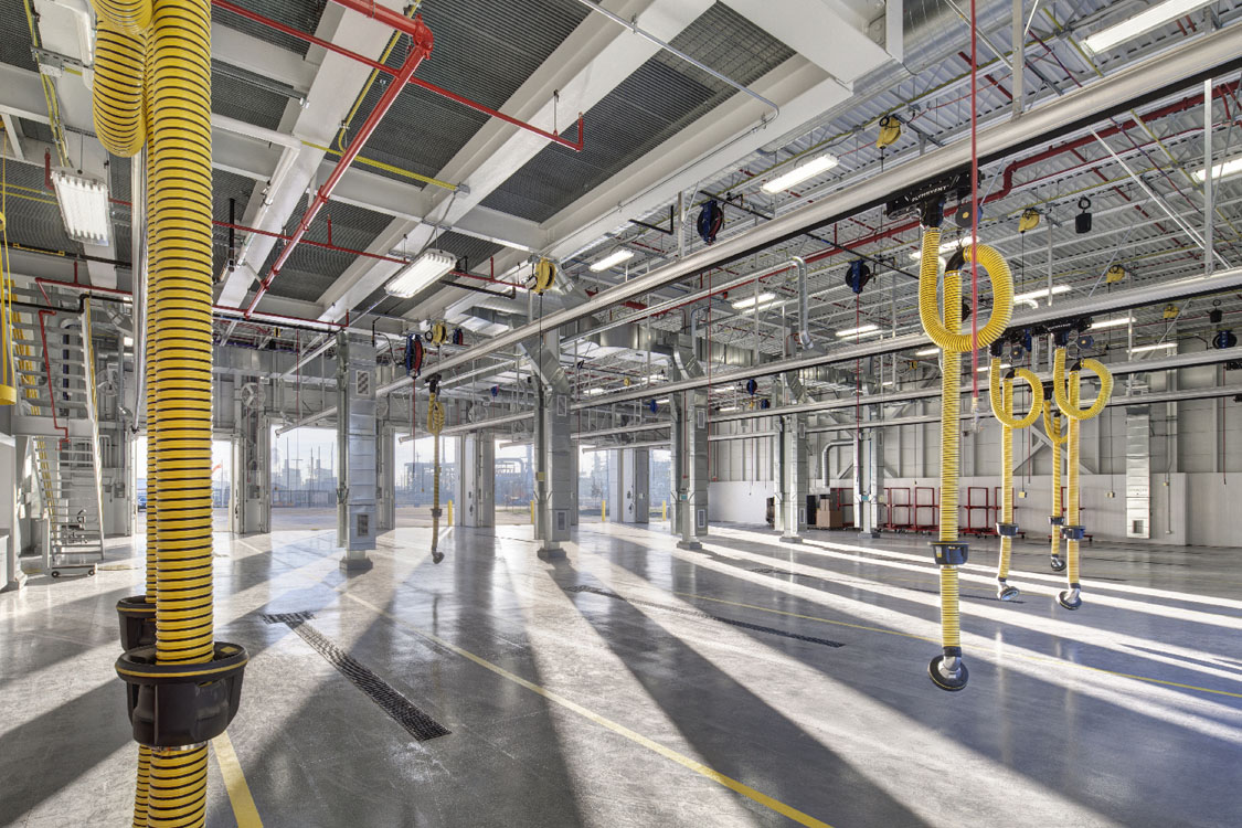 The interior of a large warehouse with yellow ropes.