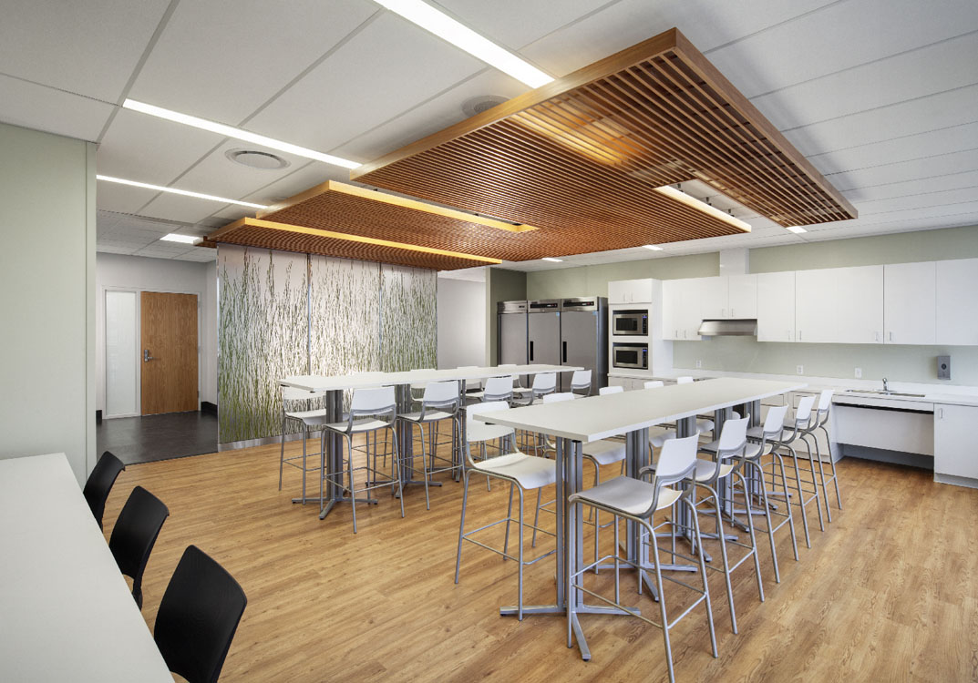 An office with a wooden ceiling and tables and chairs.