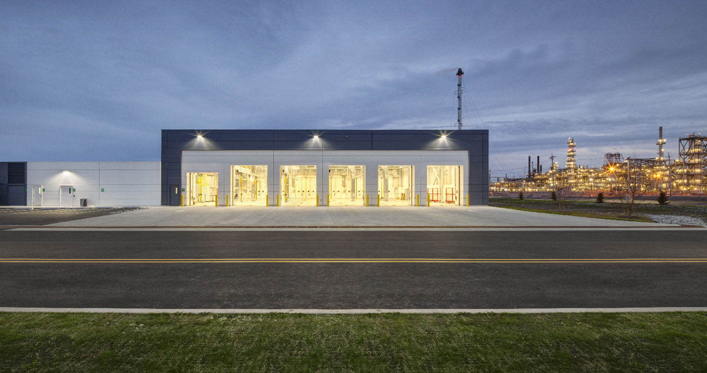 A large industrial building at dusk.