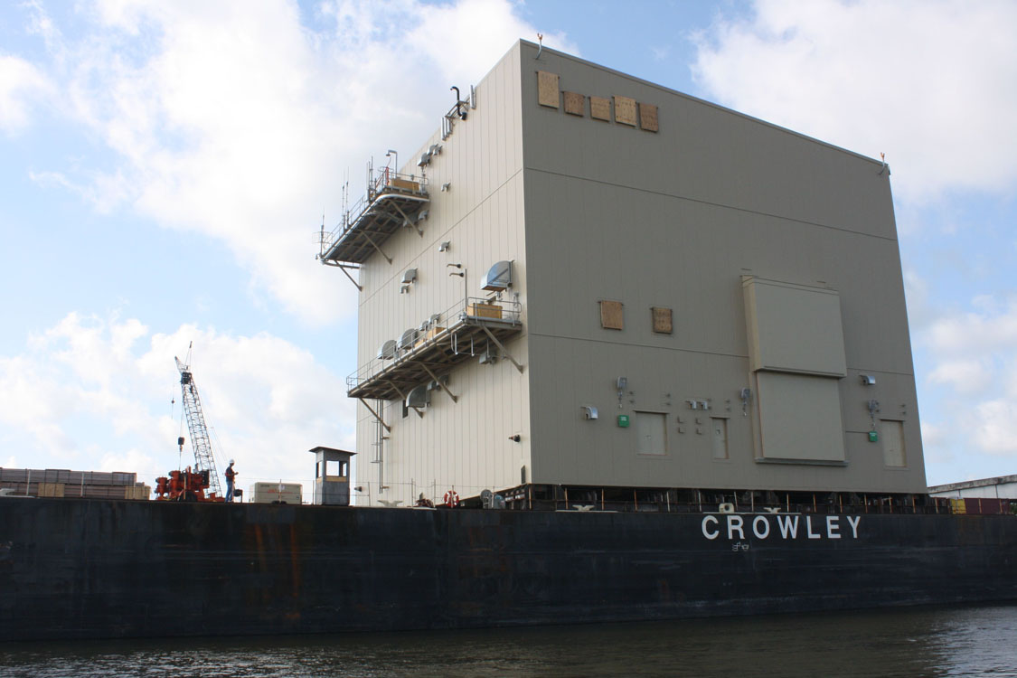 A large ship in the water with a crane on it.