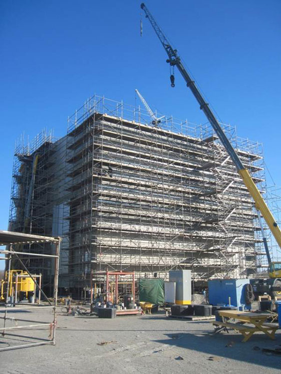 A large building under construction with a crane.