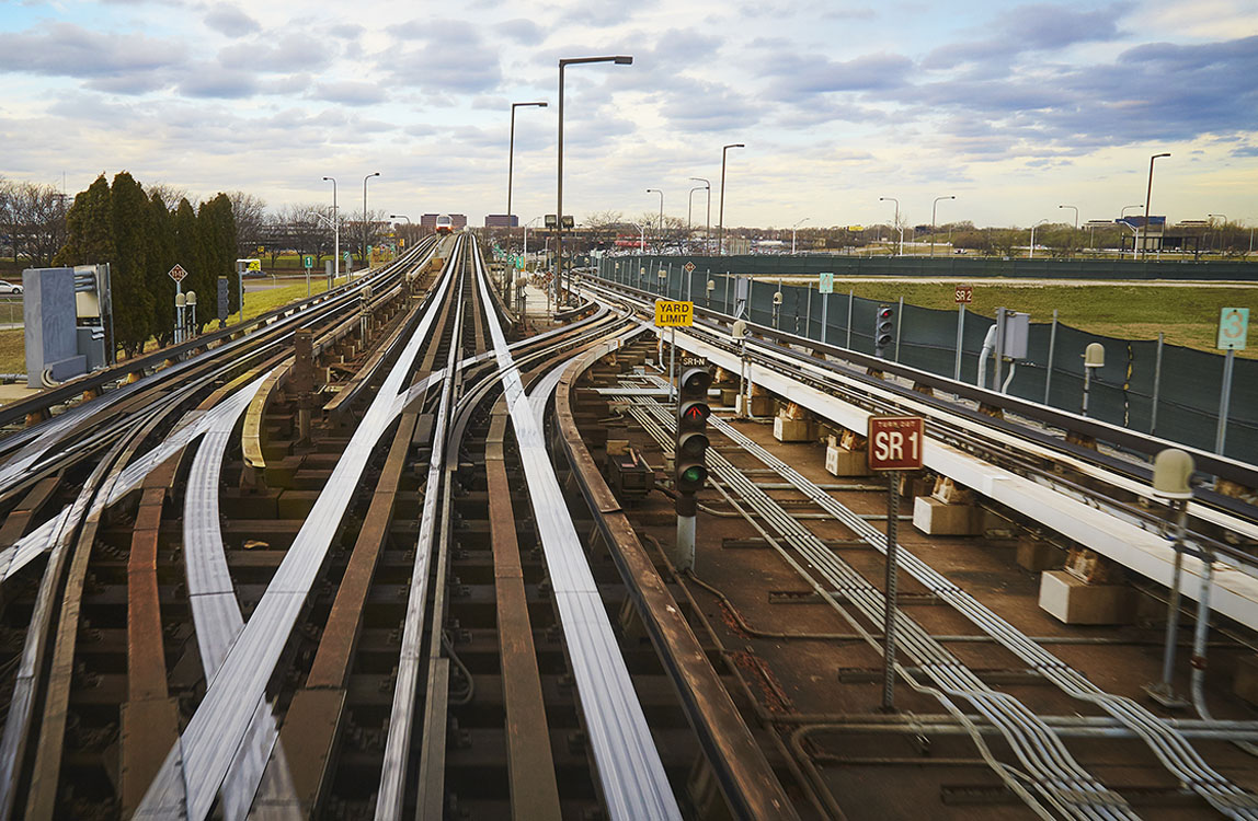 A train tracks with a cloudy sky.