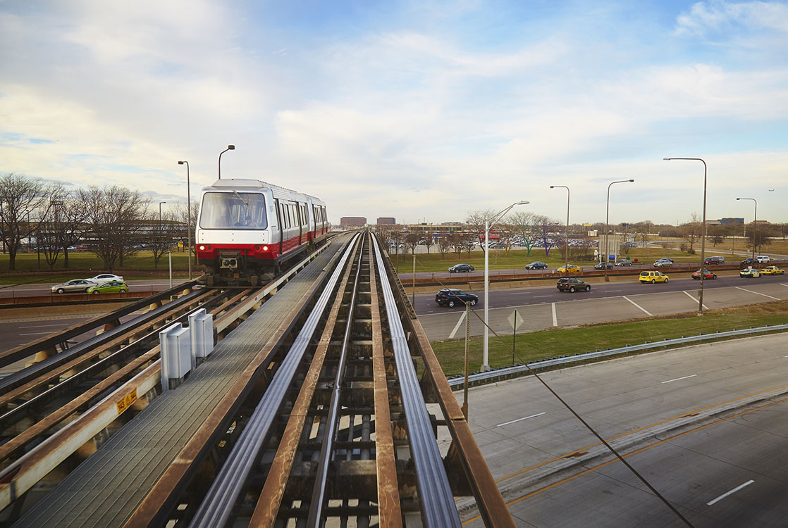 A train is traveling down a track in a city.