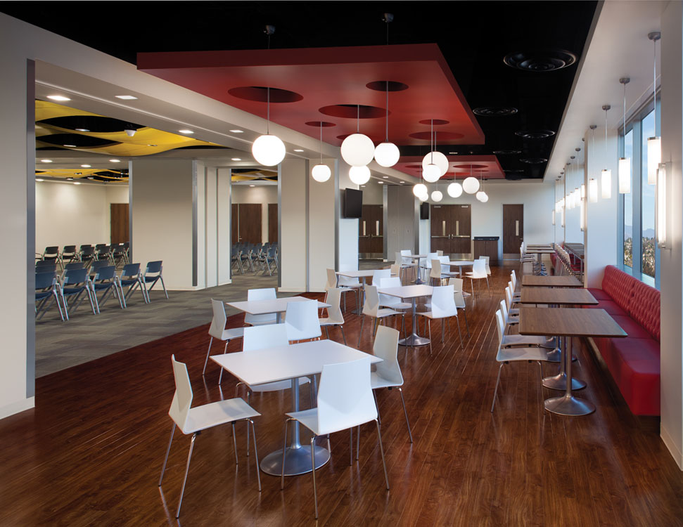 A dining room with tables and chairs.