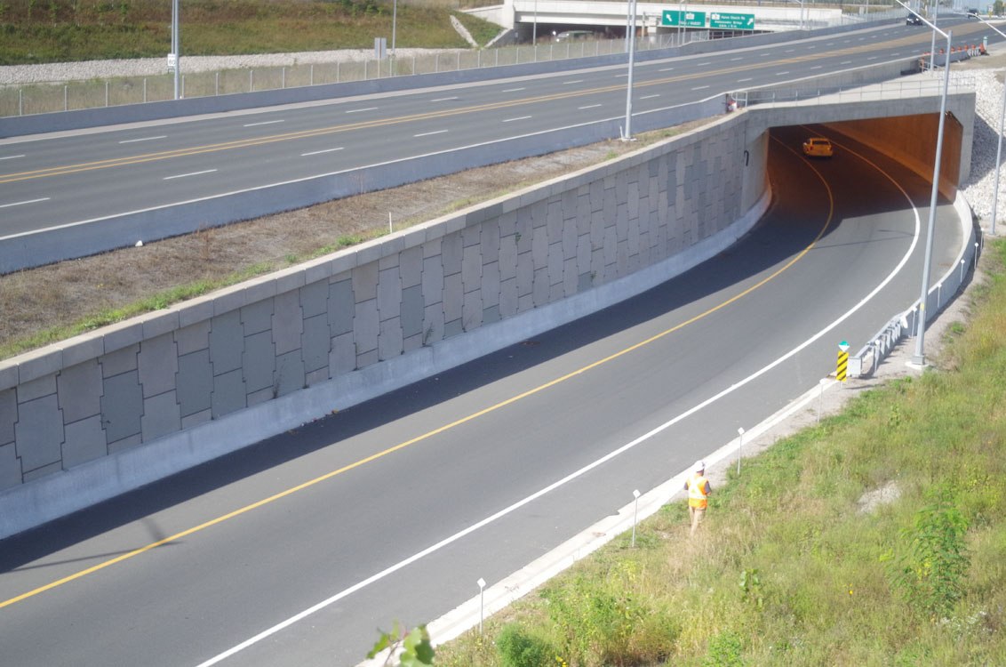 An aerial view of a highway with a tunnel.