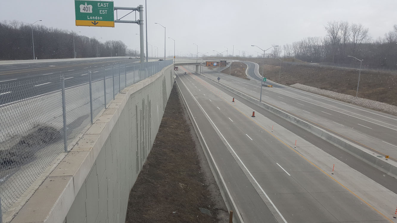 A highway with a concrete barrier in the middle of it.