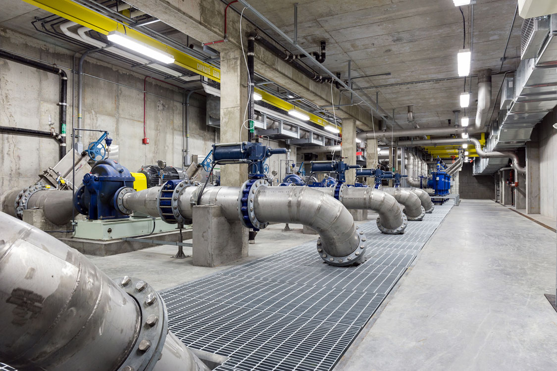 A line of pipes in a large industrial building.