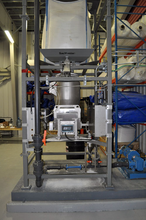 A large machine is sitting on a table in a warehouse.