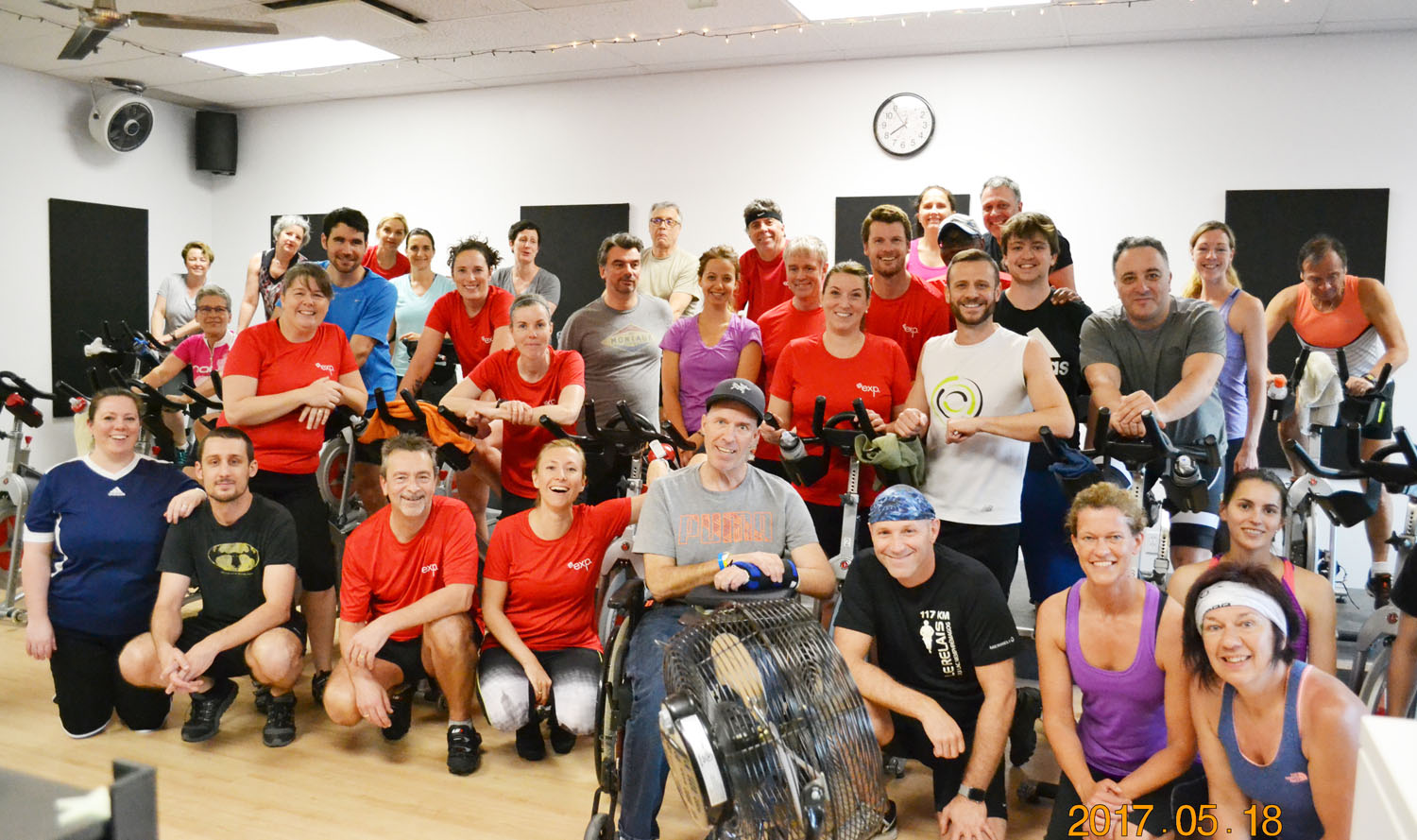 A group of people posing for a photo in a gym.