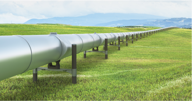 A large pipe in the middle of a grassy field.