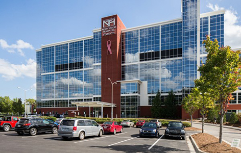 A large building with cars parked in front of it.