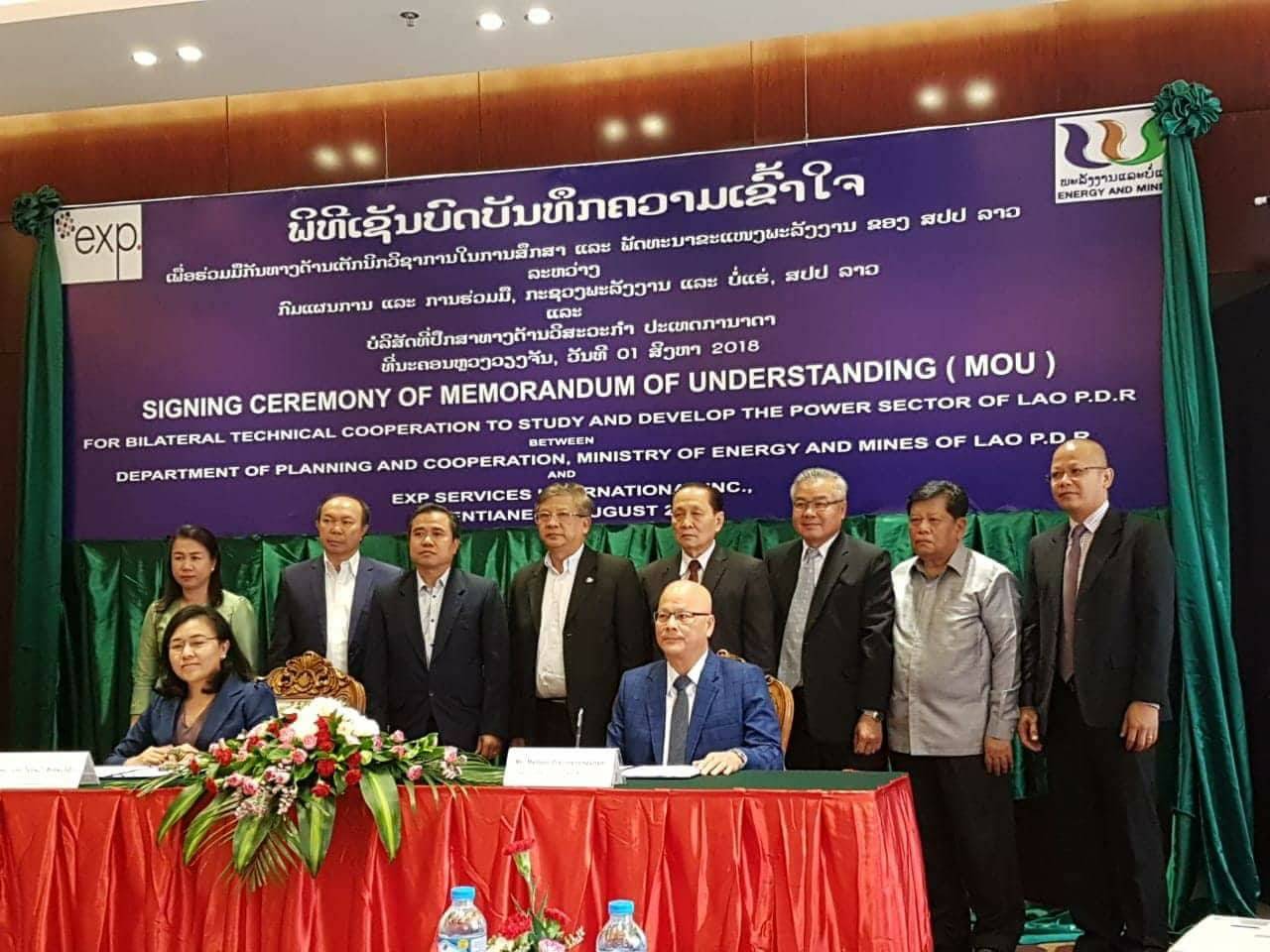 Mathieu Pravongviengkham (pictured right at the table) attends the signing ceremony of new landmark agreement in Laos.