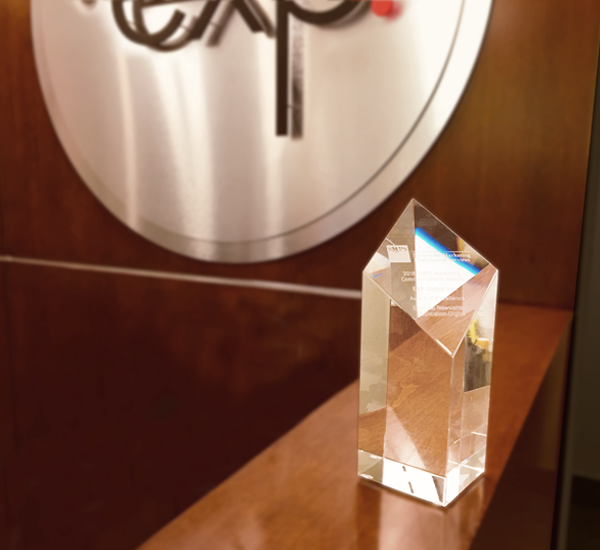 A crystal award sits on top of a wooden table.