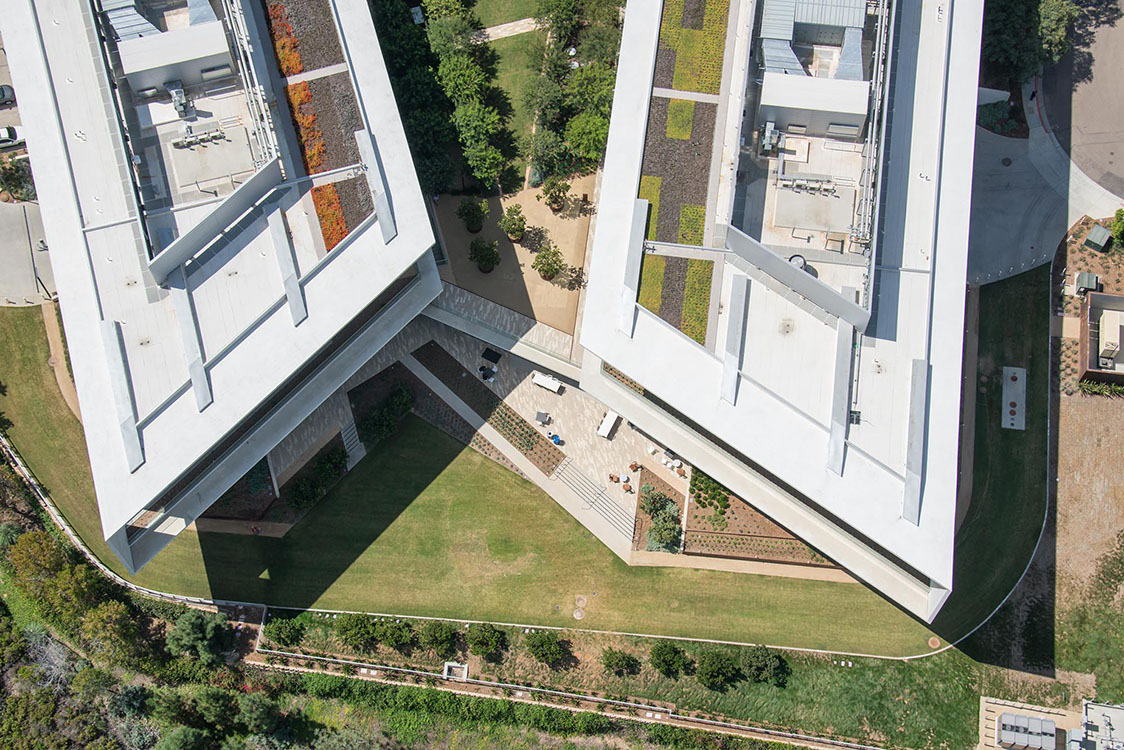 An aerial view of a building with a green roof.