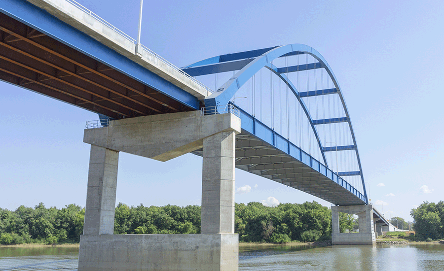 A blue bridge over a body of water.