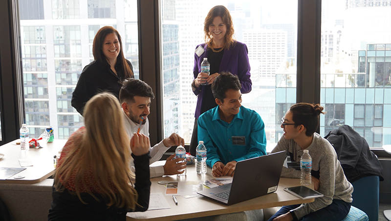 A group of people sitting around a table.