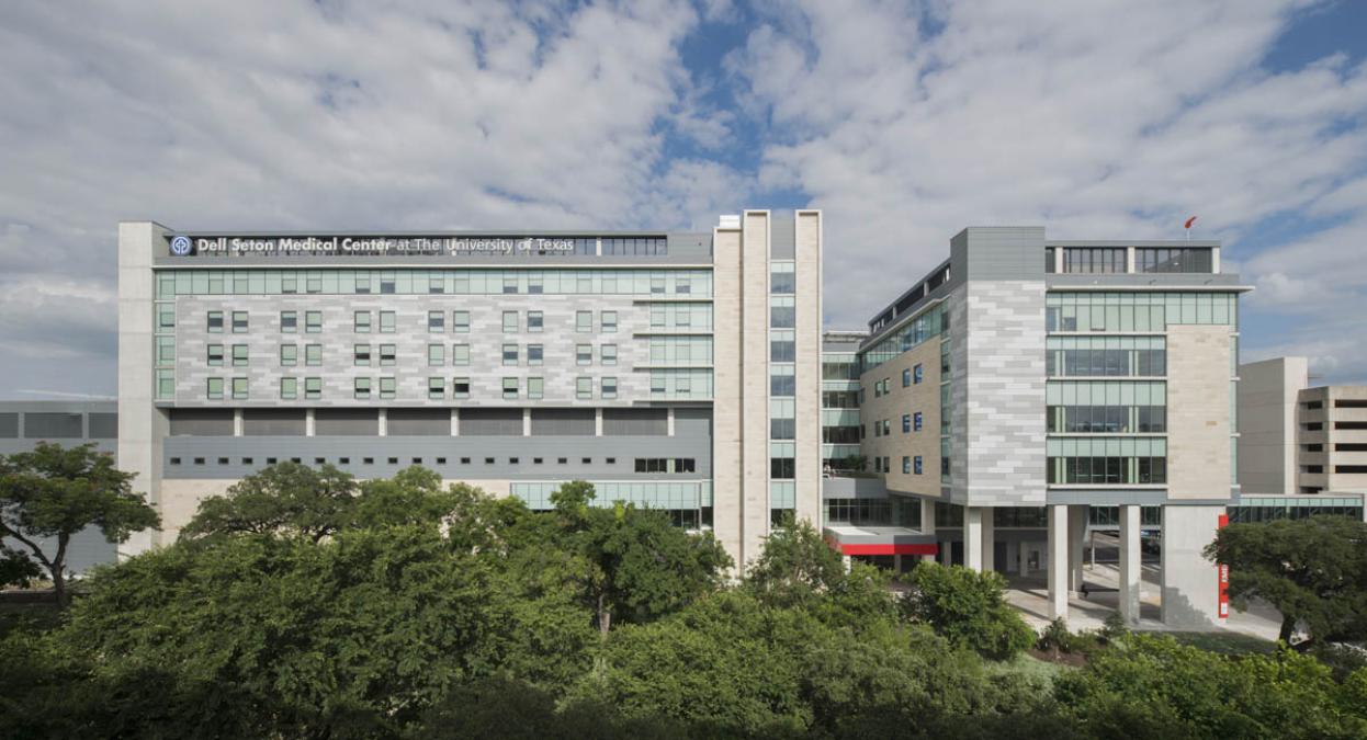 The exterior of a large EXP building with trees surrounding it.