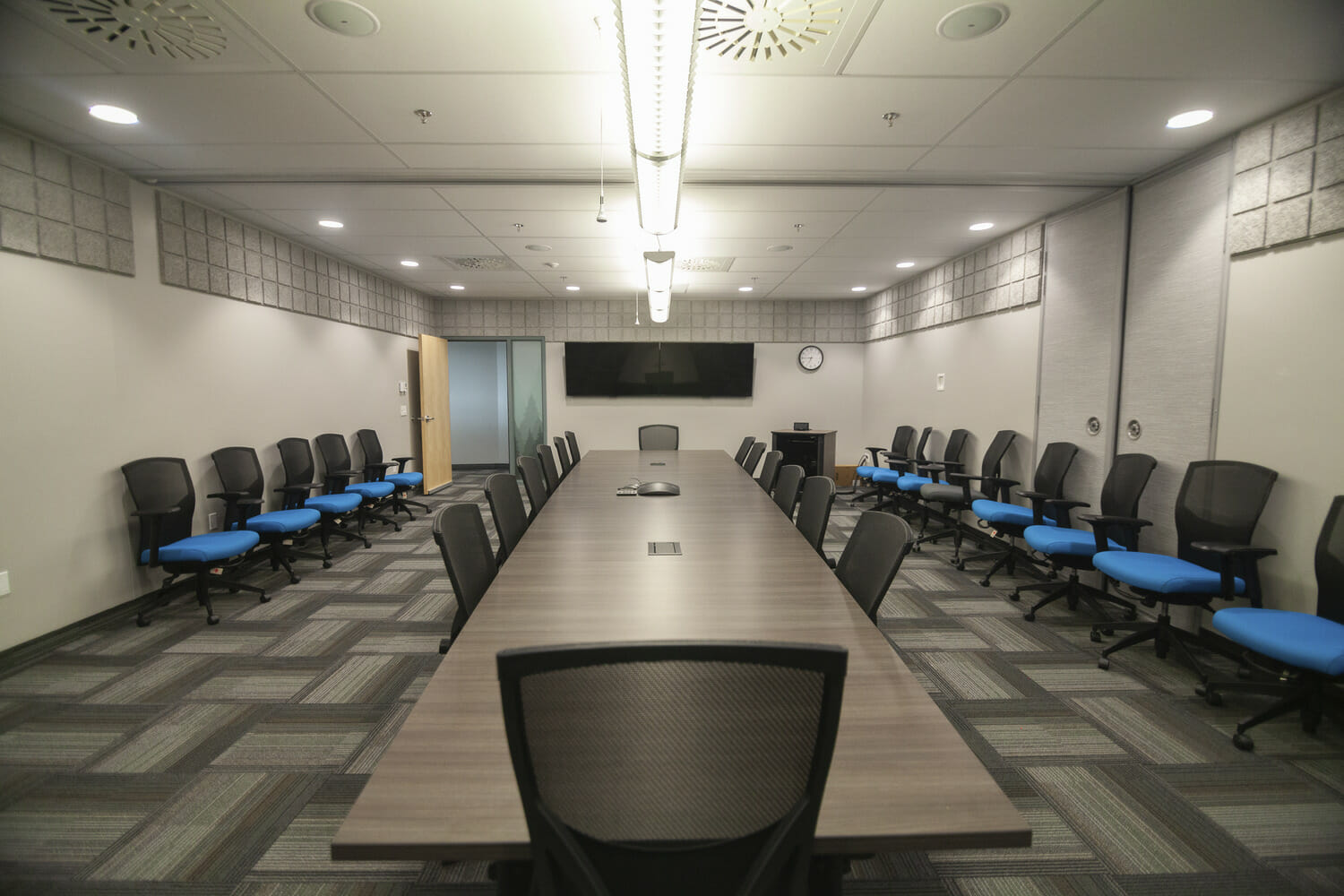 A conference room with a long table and chairs.