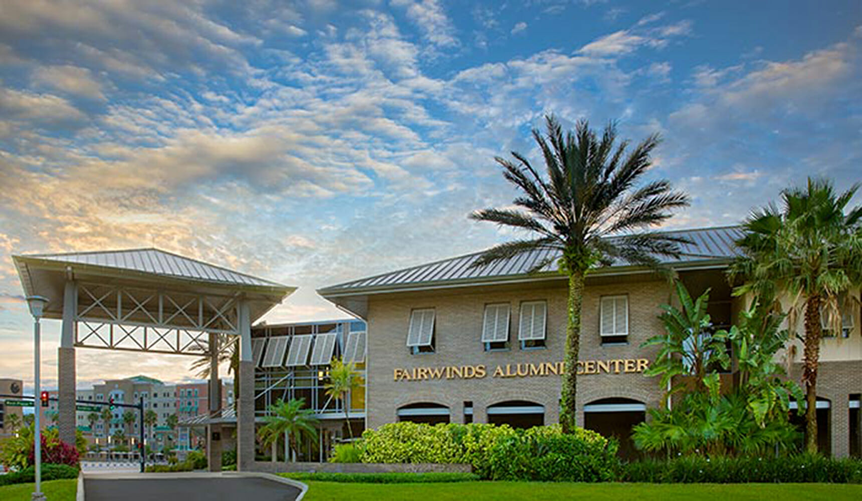 A building with a palm tree in front of it.