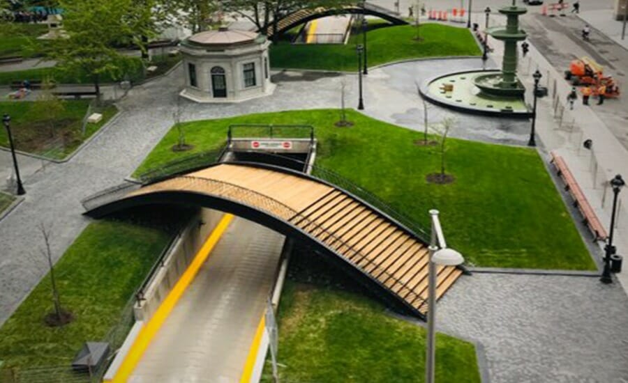 An aerial view of a bridge over a grassy area undergoing revamp in Montreal.