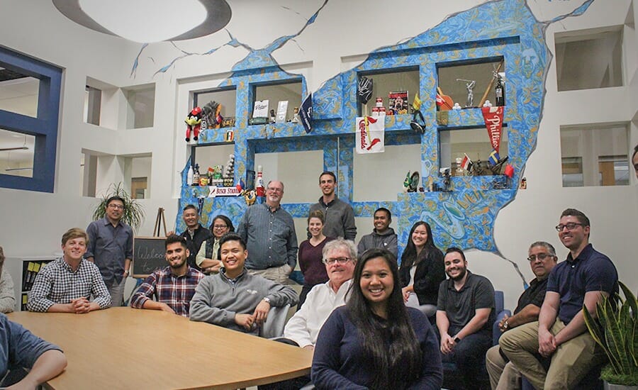 A group of people posing for a picture in an office.