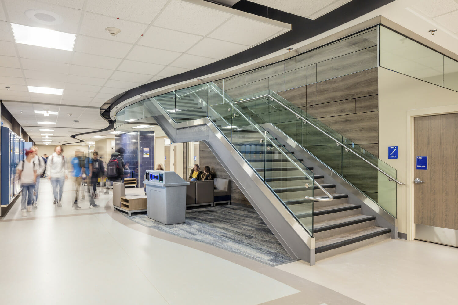 The lobby of EXP Hospital with a glass staircase.