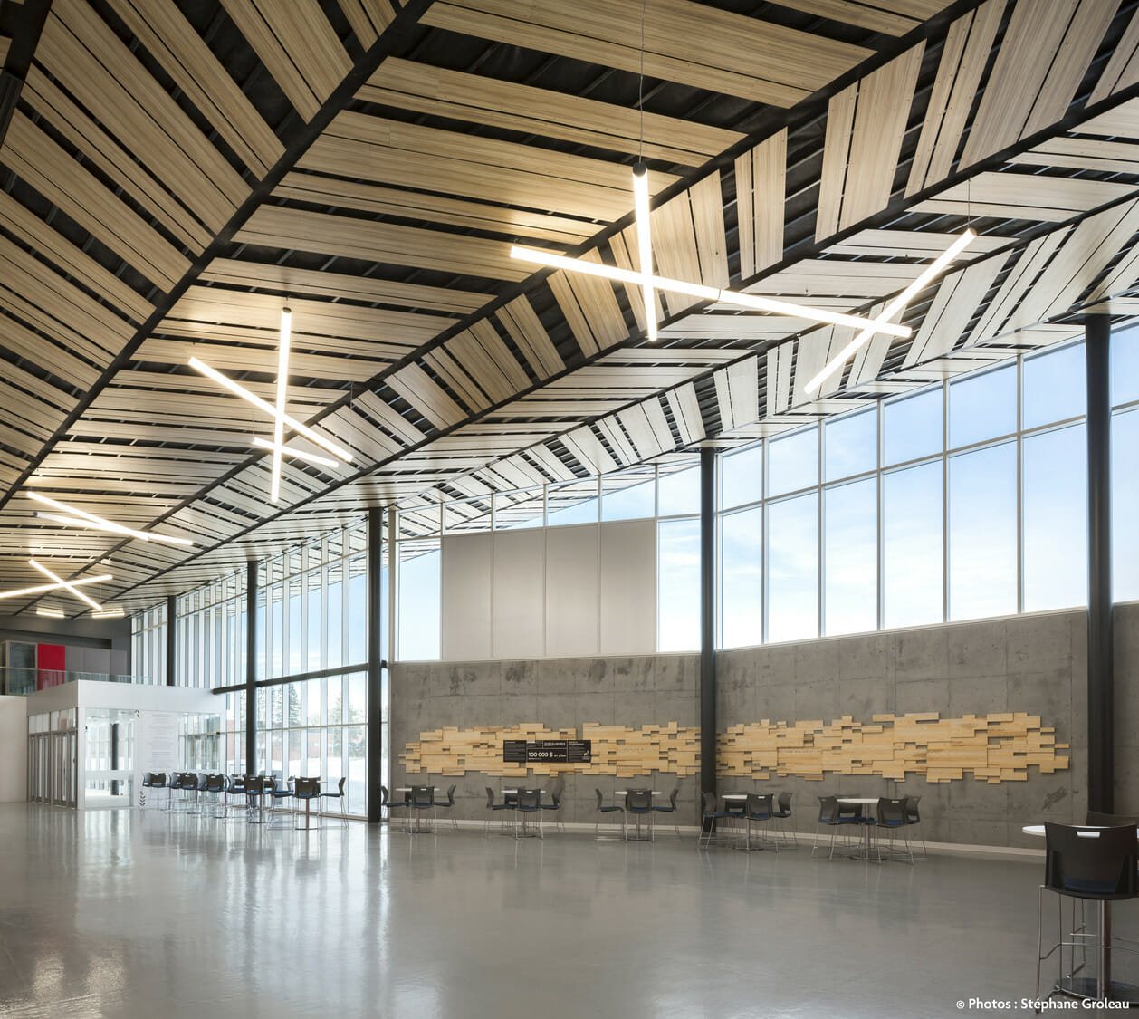 The interior of an airport with a wooden ceiling.