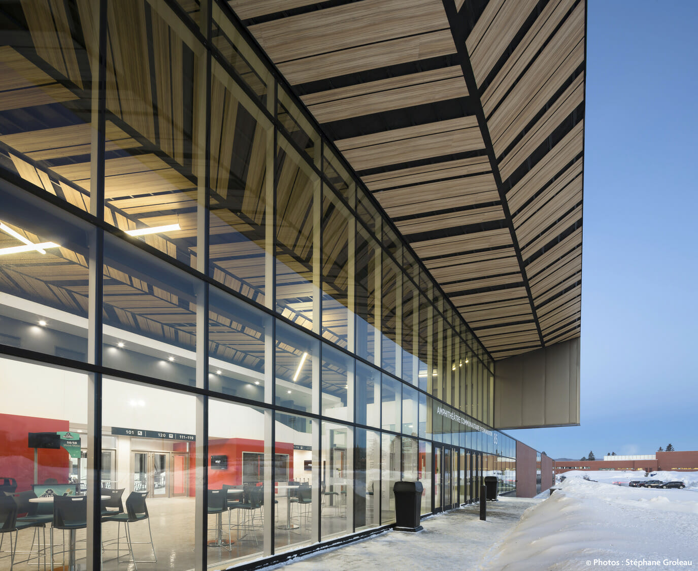 The exterior of a building with a large glass wall.