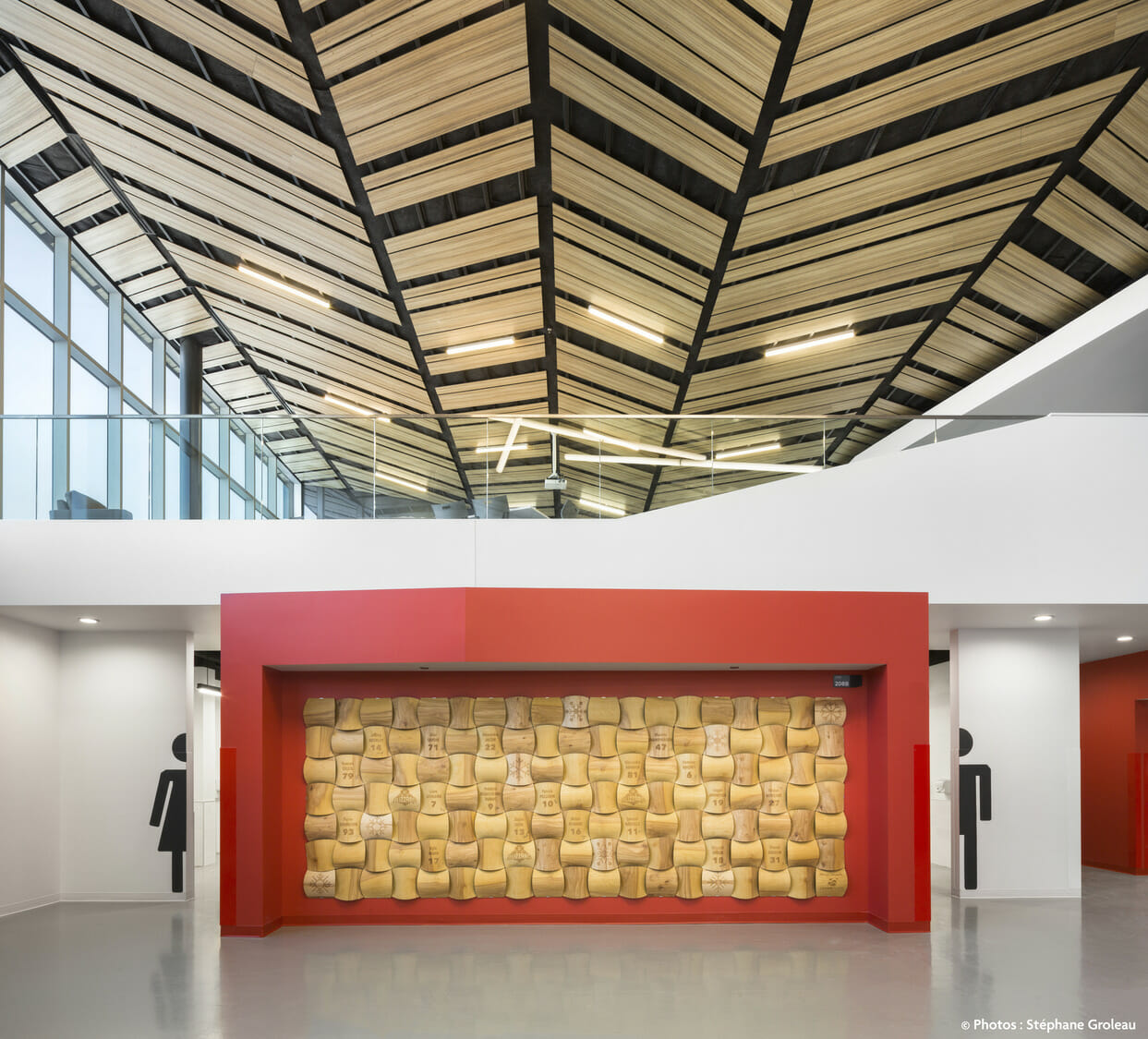 An office with a wooden ceiling and red walls.