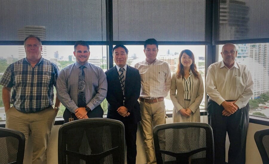 A group of people posing for a picture in an EXP office.