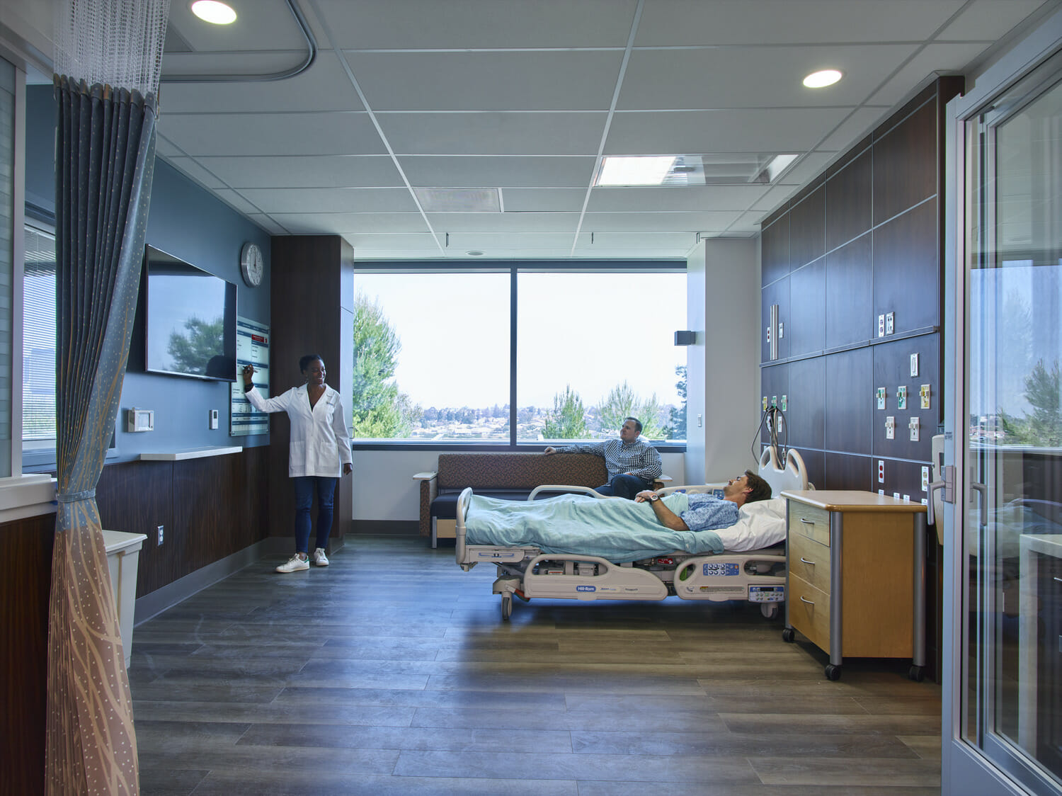 A woman receiving healthcare in a hospital room.