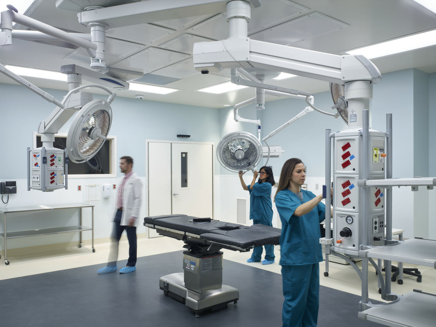 A group of medical professionals standing in a healthcare room.