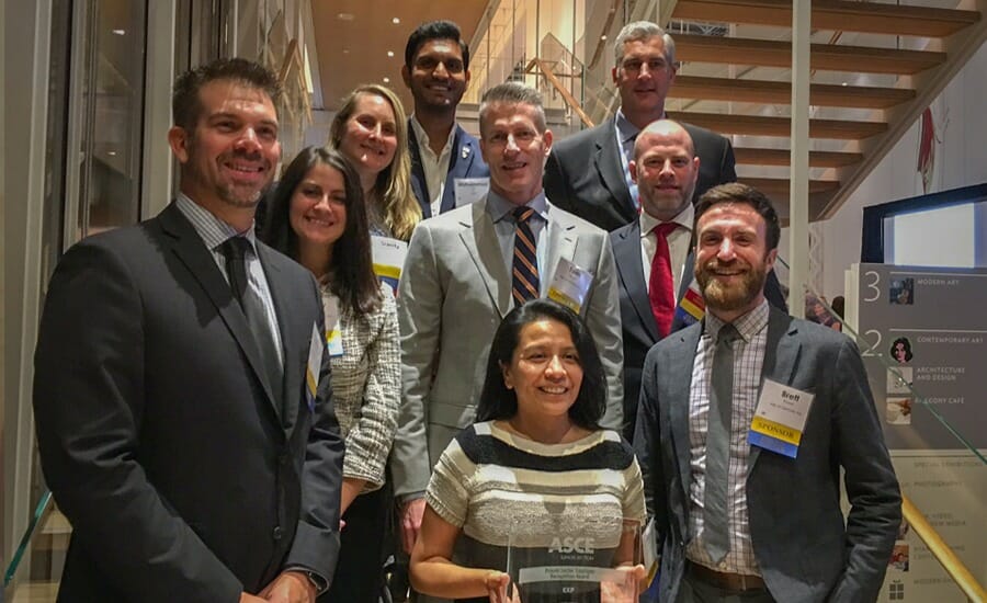 A group posing with an EXP Private Sector Employer Recognition Award.