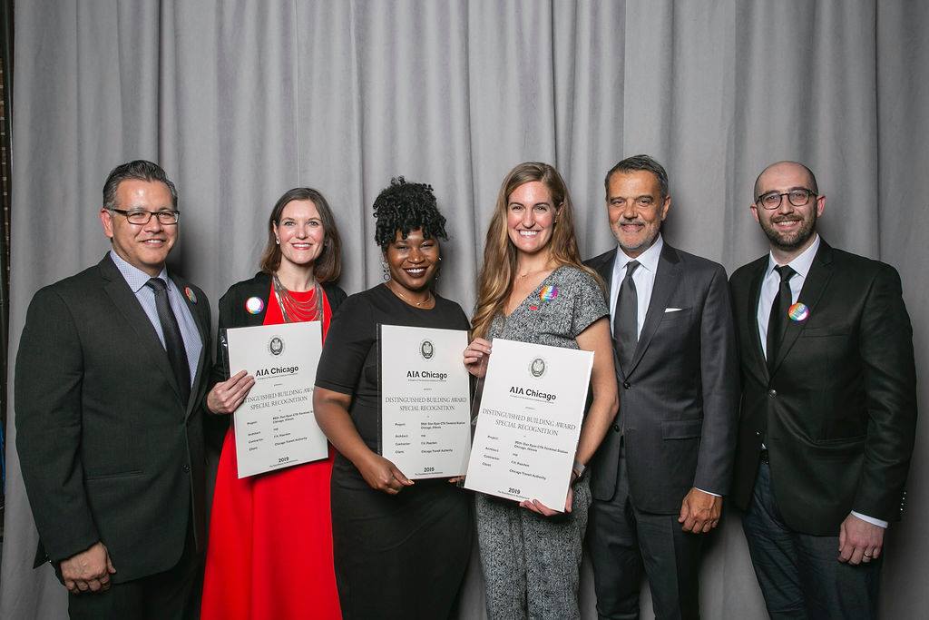 A group of people posing for a photo with their certificates.