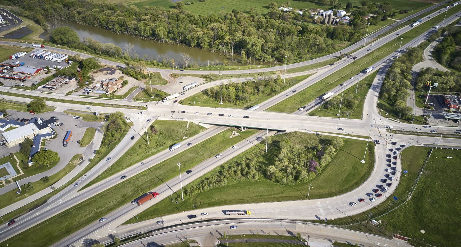 An aerial view of a highway intersection undergoing construction.