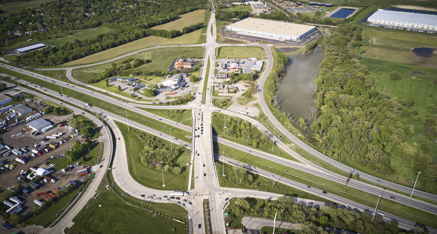 An aerial view of a highway intersection undergoing construction.
