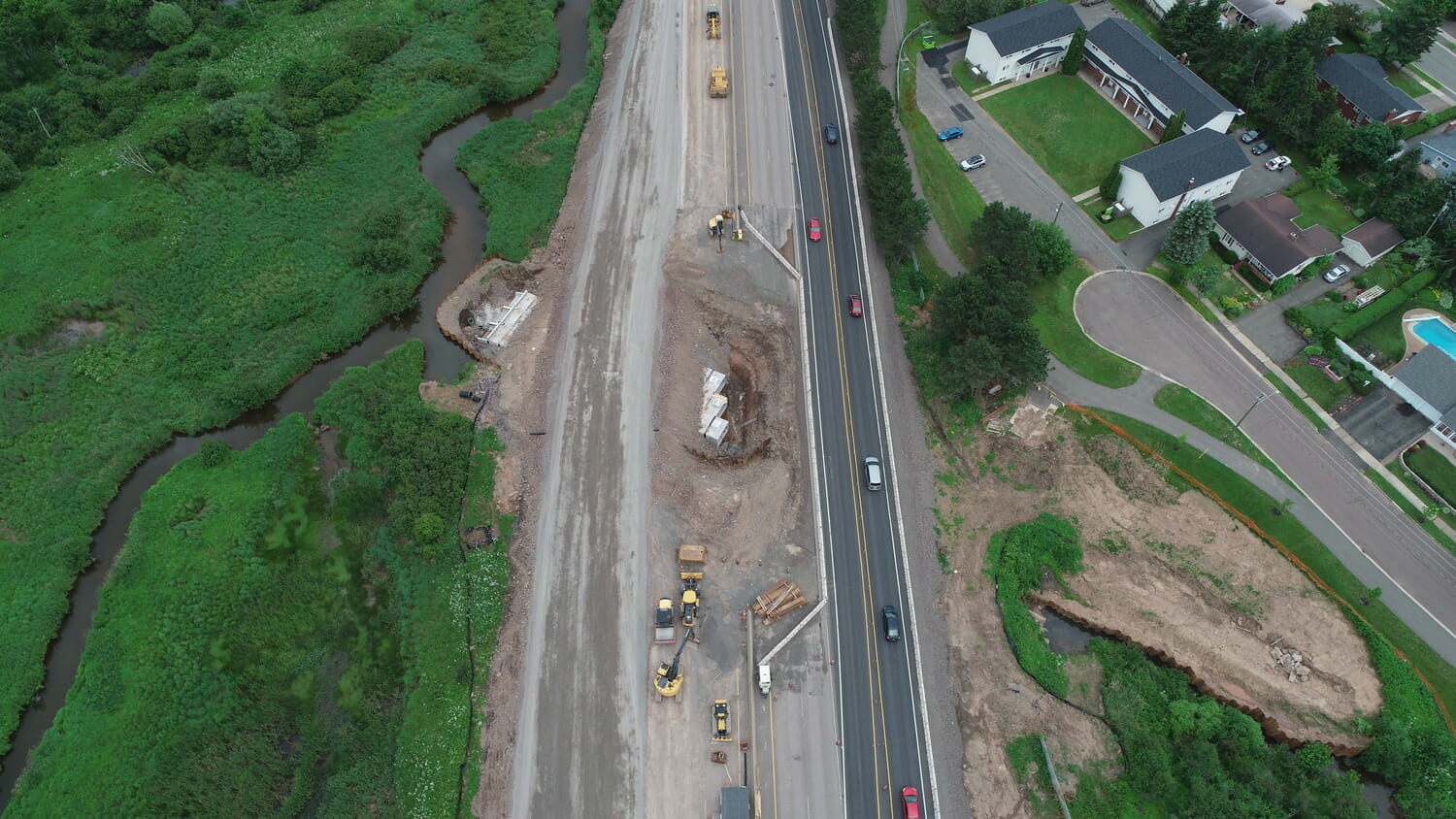 An aerial view of highway construction with an expanded culvert.