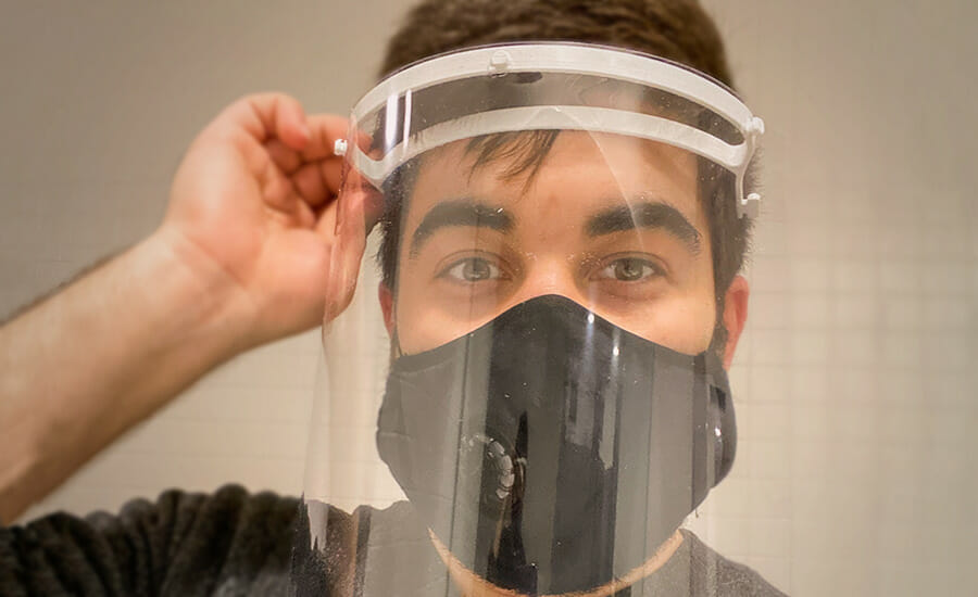 A man wearing a clear face mask.