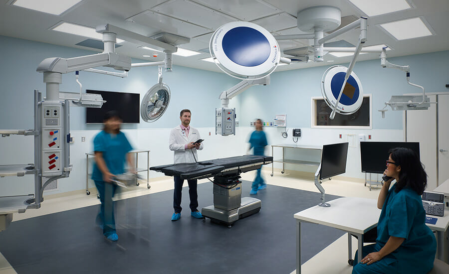 A group of people standing in a medical room.