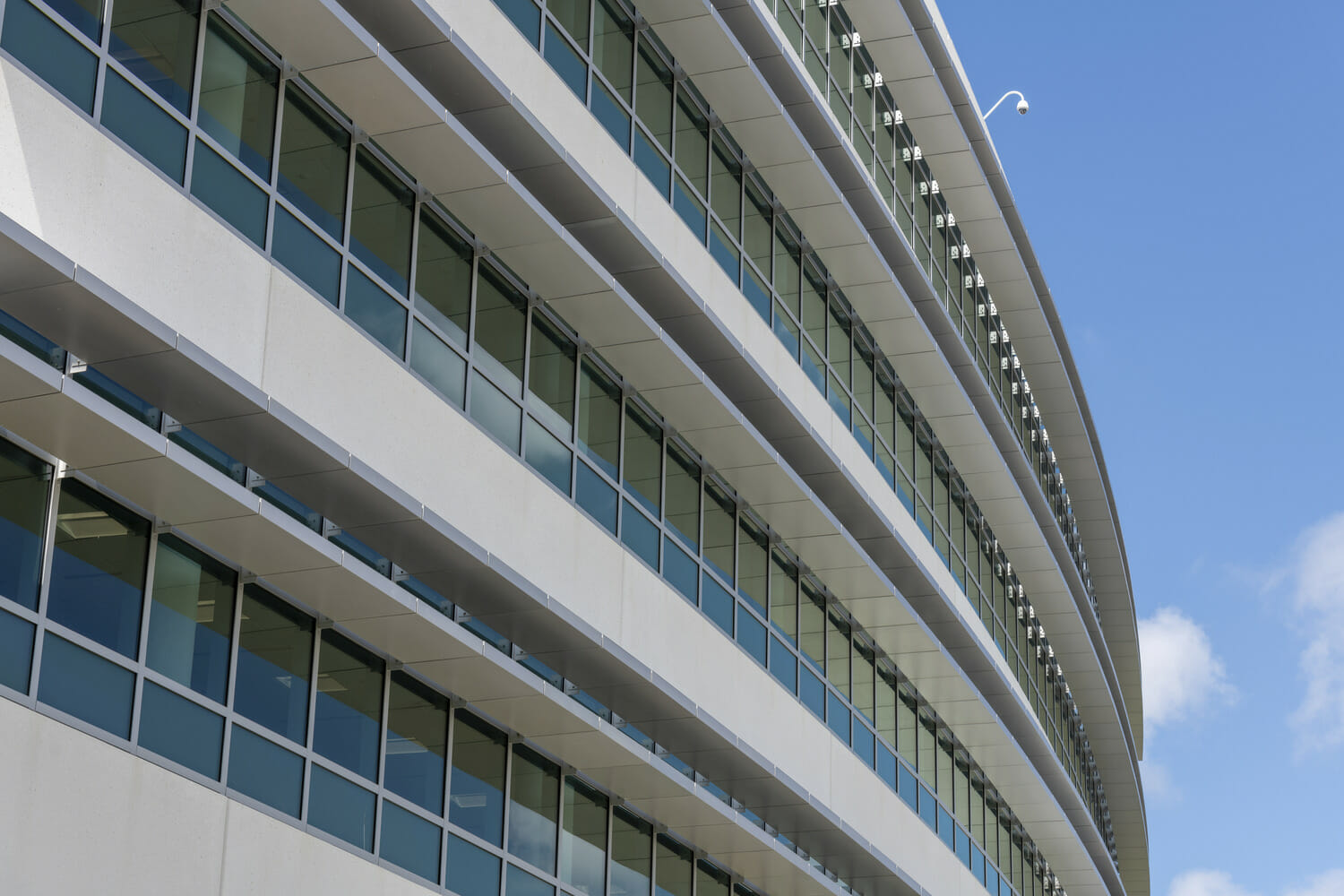 A white building with a blue sky.