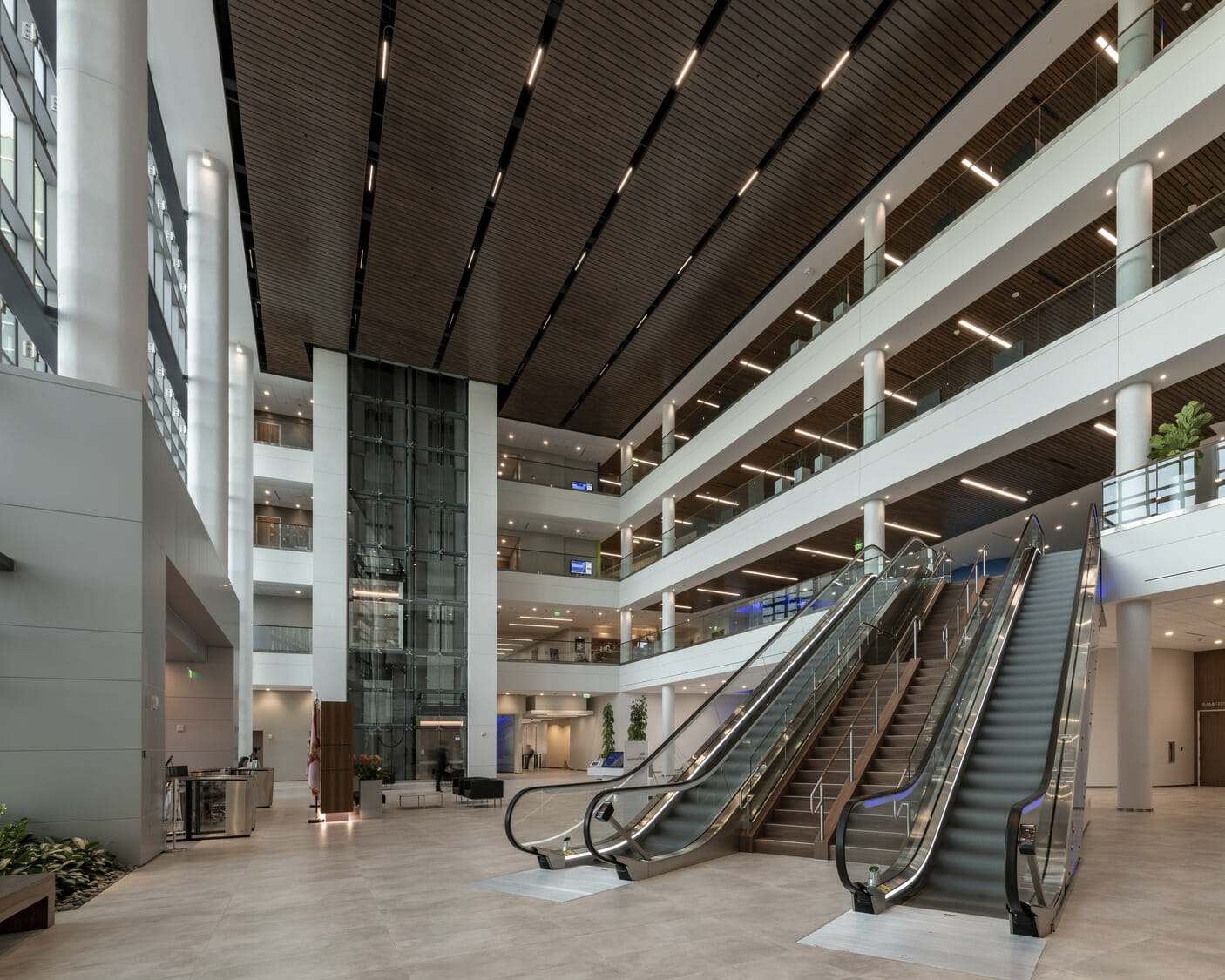 A large lobby with escalators and glass walls.