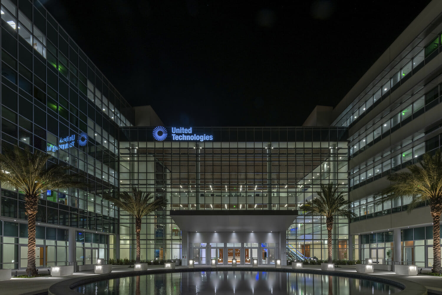 The entrance to a large office building at night.