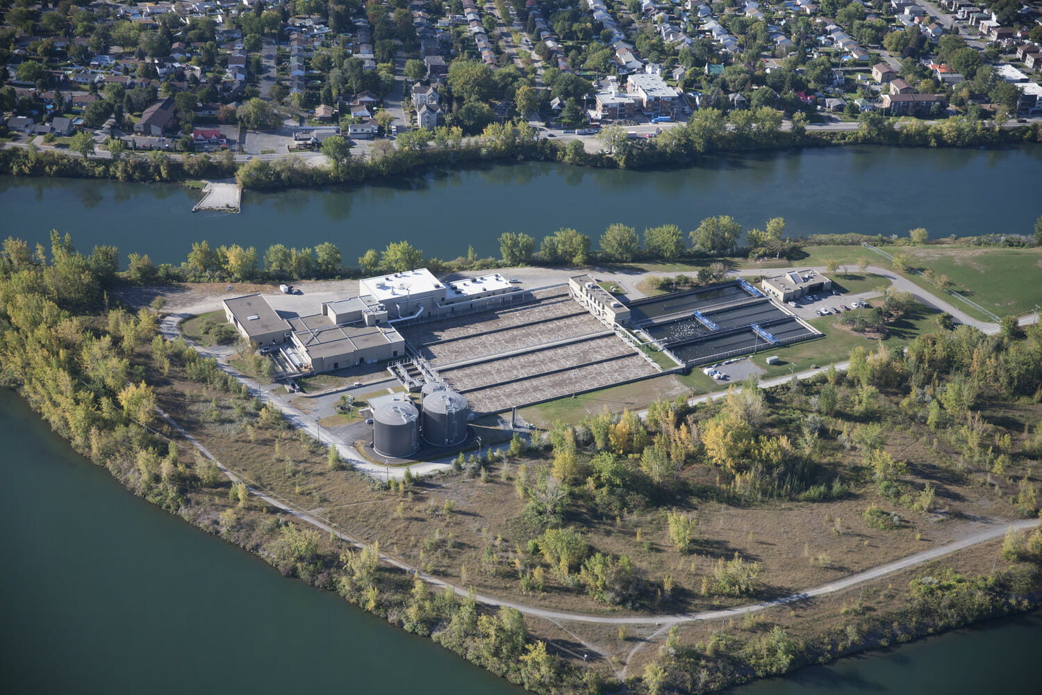 An aerial view of a large building near a river.